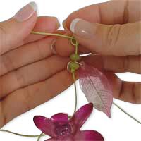 The cord is being tied to a leaf component.